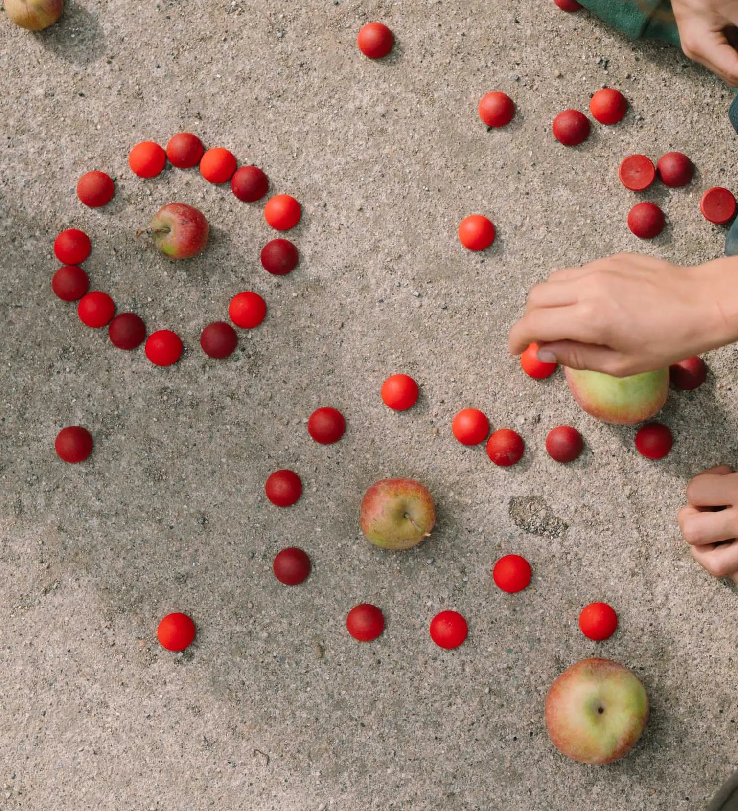 Child playing with the Grapat handcrafted wooden half sphere mandala pieces on a concrete floor