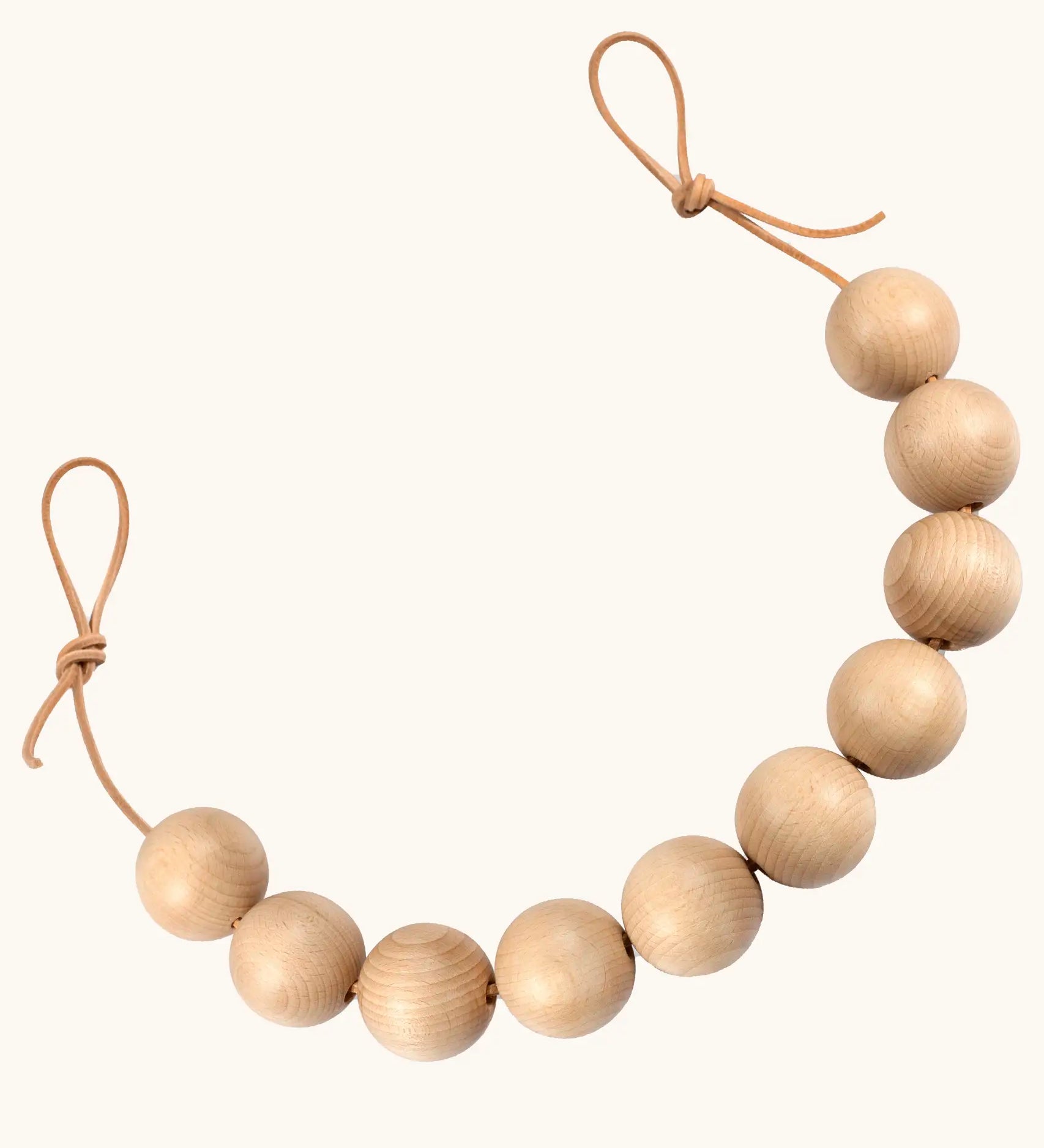 Grapat handcrafted garland. A sensory toy showing 10 natural wooden balls on a rope