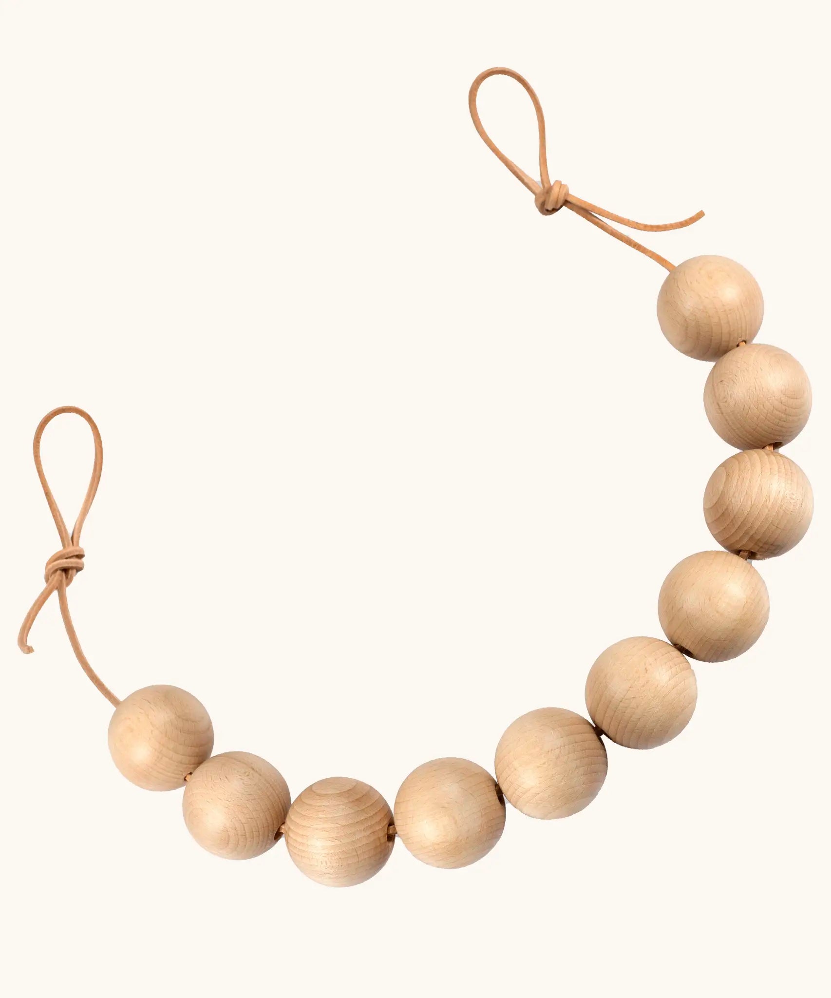 Grapat handcrafted garland. A sensory toy showing 10 natural wooden balls on a rope