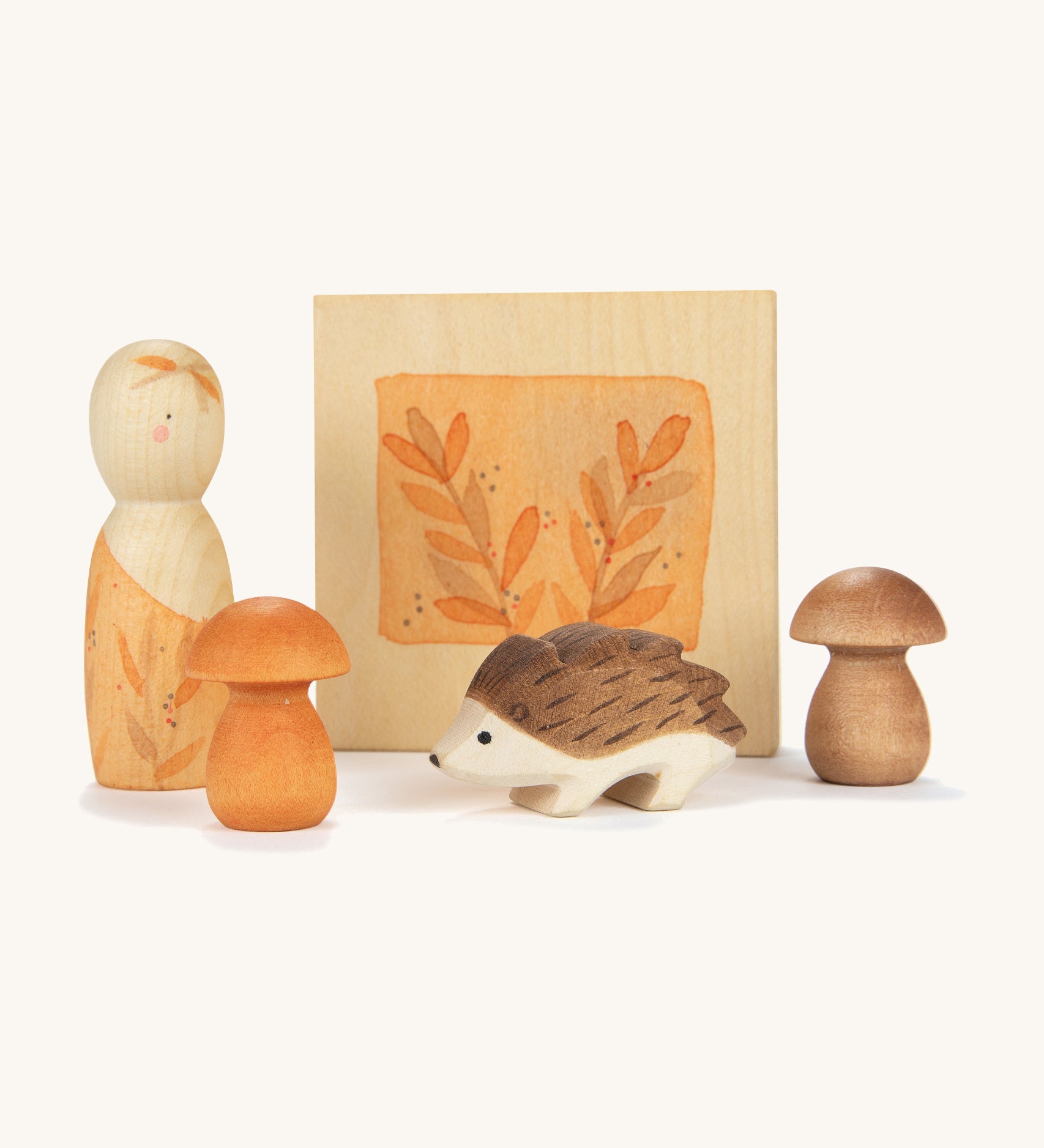 Grapat / Ostheimer hello Autumn wooden set available at Babipur. Features 5 hand cut and hand painted figures and pieces including a peg doll, small decorative flower press, hedgehog and 2 Autumn  coloured mushroom pieces. 