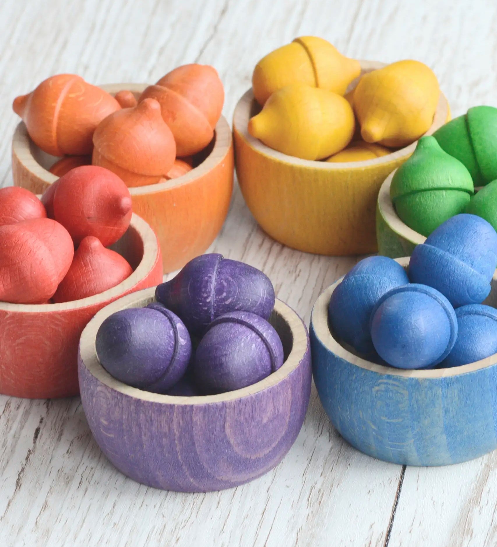 Grapat handcrafted wooden rainbow bowls with small coloured acorn pieces