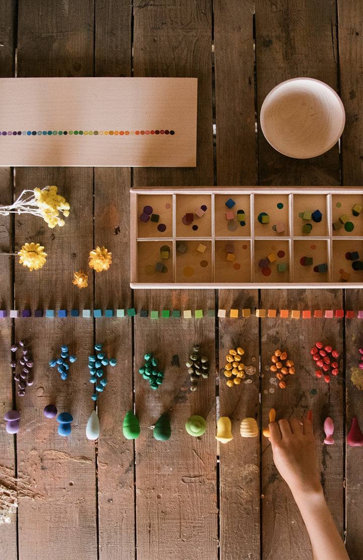 Grapat Mis and Match, a collection of rainbow coloured wooden cubes in a wooden organiser box, perfect for colour sorting and open ended play, to represent Grapat toys at Babipur.