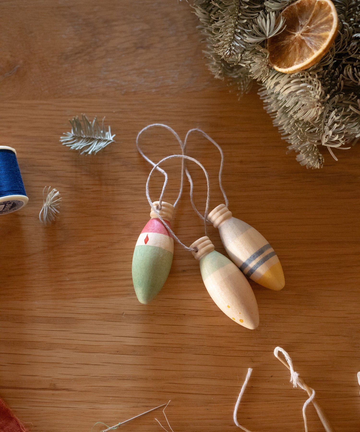 Grapat Handmade and handpainted Wooden winter sparkle decorations available at Babipur on a wooden table