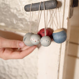 A set of 5 Grapat winter handmade and hand painted wish balls hanging from a door handle