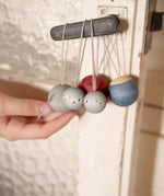A set of 5 Grapat winter handmade and hand painted wish balls hanging from a door handle
