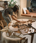 2 children baking festive cookies in a kitchen setting with Grapat wooden peg doll pieces from the Grapat advent calendar available at Babipur