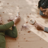 2 children playing with different handmade and hand painted wooden pieces from the Grapat 2025 advent calendar available at Babipur.