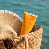 Green People SPF50 water repellent sun cream inside a basket by the sea