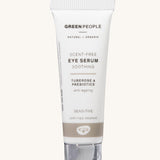 The Green People Scent Free Eye Serum is soothing for sensitive skin, organic, and anti-ageing. The cream is in a white tube with a silver lid and a light brown stripe. The image is on a cream background