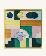 Grimm's wooden movement building set in a yellow square frame shows handcrafted pieces in different colours