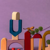 Close up of Grimm's wooden panorama building set pieces stacked on top of eachother