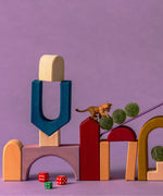 Close up of Grimm's wooden panorama building set pieces stacked on top of eachother