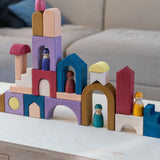 Grimm's wooden panorama building set on a wooden table. Shows different pieces stacked on top of each other 