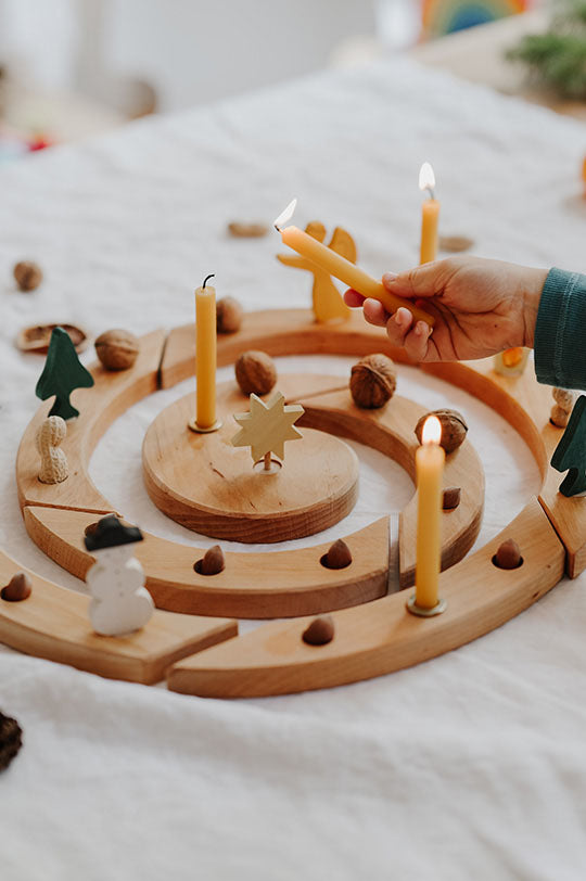 Grimm's Spiral Natural Celebration Ring with Christmas figures and candles to represent Grimm's Celebration Ring and Decorative Figures for sale at Babipur, official UK stockist.