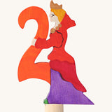 Grimms number 2 fairy decorative figure available at Babipur. A orange wooden number 2 figure with a red queen latching on. 