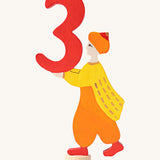Grimms number 3 fairy decorative figure available at Babipur. A red wooden number 3 figure with a king holding the number