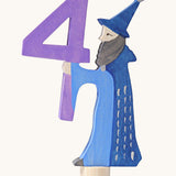 Grimms number 4 fairy decorative figure available at Babipur. A purple wooden number 4 figure with a blue wizard latching on. 