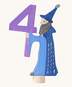 Grimms number 4 fairy decorative figure available at Babipur. A purple wooden number 4 figure with a blue wizard latching on. 