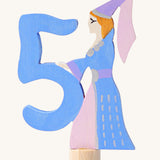 Grimms number 5 fairy decorative figure available at Babipur. A light blue wooden number 5 figure with a blue and pink princess latching on. 