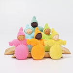 The Grimm's Pastel Dwarfs dolls stood on natural wooden boards, on a light grey background