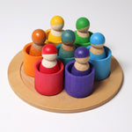 The Grimm's Wooden Friends Peg Dolls sat in the Wooden Grimm's bowls on a cream background