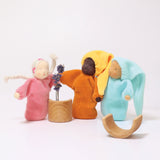 The Grimm's Lavender Dolls stood next to each other, with pieces of the Grimm's small natural rainbow and a sprig of lavender