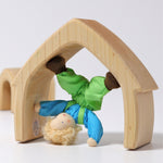 Grimm's Blond Boy Doll - Linde is playing in one of the Grimm's Natural Wooden arches and is upside down doing a headstand. 