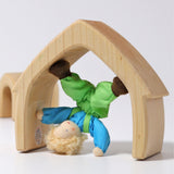 Grimm's Blond Boy Doll - Linde is playing in one of the Grimm's Natural Wooden arches and is upside down doing a headstand. 
