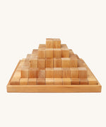 Grimm's Natural Large Stepped Pyramid in a wooden storage display tray.