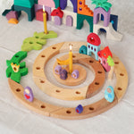 Grimm's natural spiral celebration ring with pieces of the Grimm's sparkling orient building set.