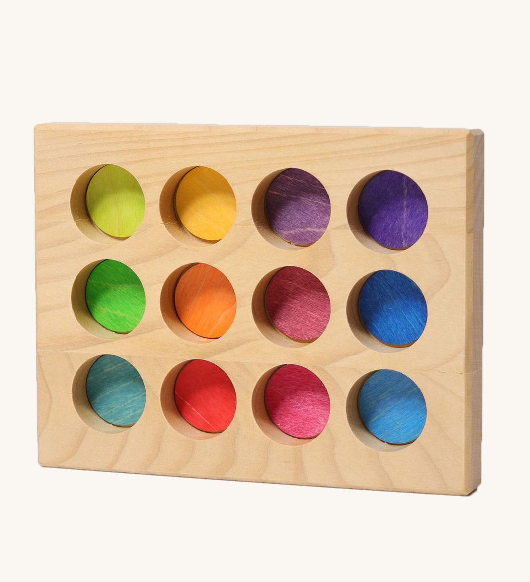 Grimms handcrafted wooden sorting board with 12 round slots in rainbow colours, made for sorting games