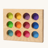 Grimms handcrafted wooden sorting board with 12 round slots in rainbow colours, made for sorting games