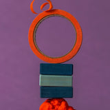 Fancy stack using 3 blue handcrafted Grimms wooden pieces from the rhythm set with orange tape on top