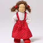 Lana is stood with its hand behind its back, showing the flexibility in the arms of the fabric doll