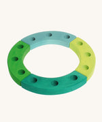 Grimm's Green-Turquoise Celebration Ring on a cream background