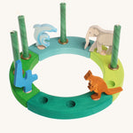 Grimm's Green-Turquoise Celebration Ring on a white background with green candles and decorative figures to celebrate a 4th birthday