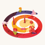 The Grimm's Red Celebration Spiral filled with Grimm's decorative figures and candles, to celebrate a second birthday on a cream background