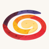Grimm's Red Celebration Spiral is made from 8 sections of wood, each with 3 holes in for decorative figures and candles, and they make a beautiful spiral. The image is on a cream background