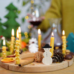 Grimm's 16-Hole Natural Wooden Celebration Ring with beeswax candles and snowman decorative figure in a Christmas display