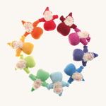 Grimm's Bearded Dwarfs in a circle. These fabric, handmade, waldorf, toy dolls, are one colour of the rainbow in red, orange, yellow, light green, teal, light blue, blue, indigo, pink and magenta. The image is on a cream background