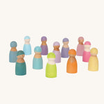 Grimm's 12 Pastel Friends, hand painted wooden peg dolls in hues of blue, pink, purple orange, green and yellow stood on a cream background