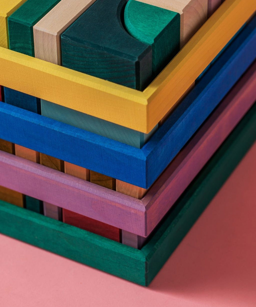 Close up of all Grimms building sets stacked on top of each other shows frame corner detail