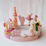 A pink inspired display including Grimms wooden flamingo, snail, ballerina and sheep decorative figure slotted in the celebration ring
