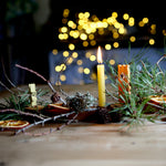 A beautiful winter display using tree leaves, and branches on top of the Grimm's Celebration Ring. There are also Grimm's Decorative figures in the display too.
