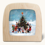 Toverlux silhouette of snowy Christmas scene, kids decorating a Christmas tree, for December celebrations.