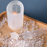 Haakaa colostrum storage tube next to a collector containter.