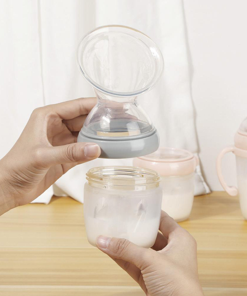 A person attaching the Haakaa Generation 3 Silicone Breast Pump Flange Attachment to a Haakaa baby Bottle