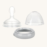 The Haakaa Generation 3 Silicone Bottle Feeding Spoon Head, on a cream background. The set come with the Silicone Feeding Spoon, Cap and ring in grey