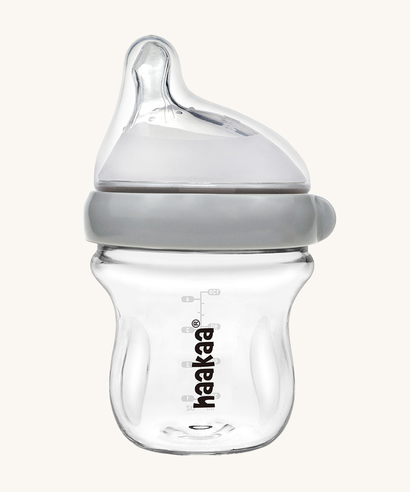 The Haakaa Generation 3 Glass Baby Bottle 120ml, in grey on a cream background