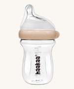 The Haakaa Generation 3 Glass Baby Bottle 180ml in peach, on a cream background